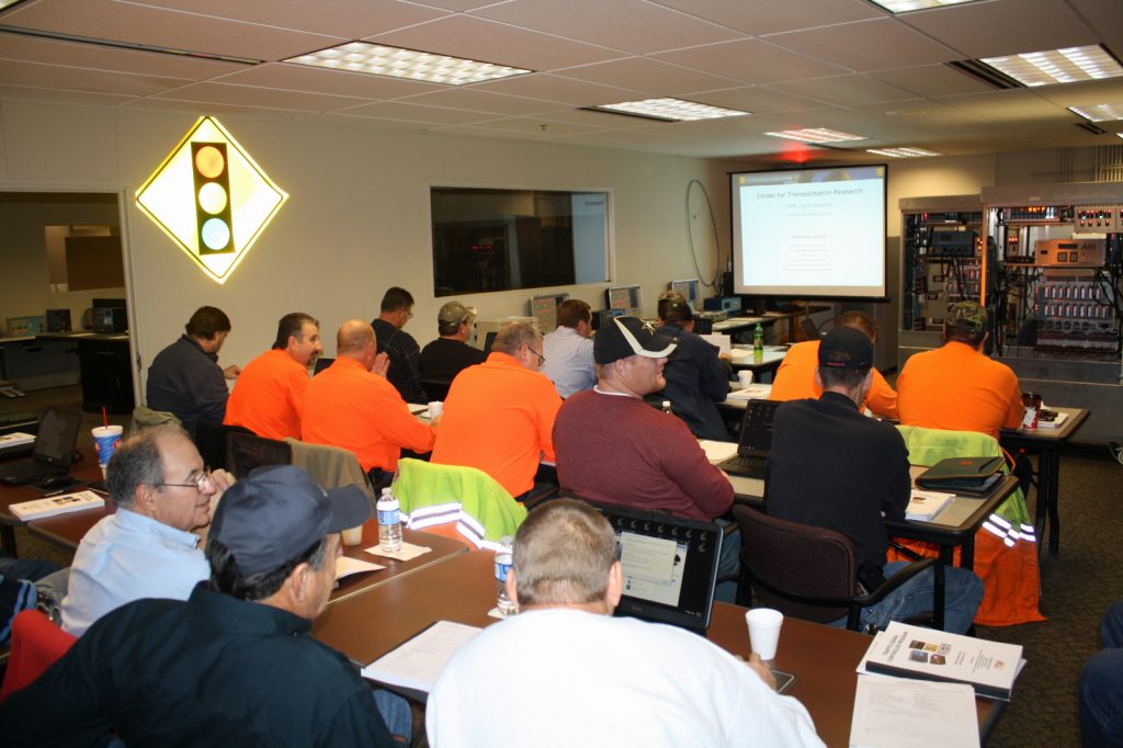 TSA students in a classroom with a projector screen displaying "Center for Transportation Research"
