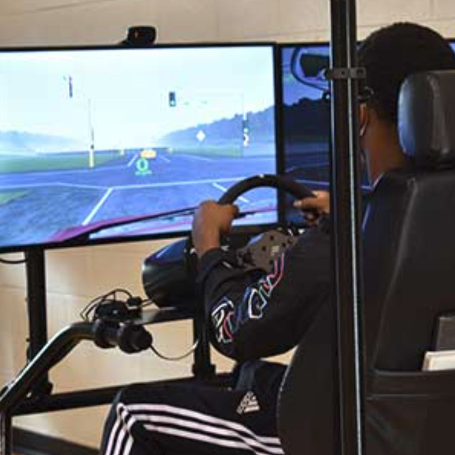 A student uses a Portable Driving Simulator from the Center for Transportation Research at UT.