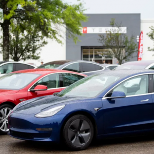 Blue Tesla in front of Knoxville Tesla dealership