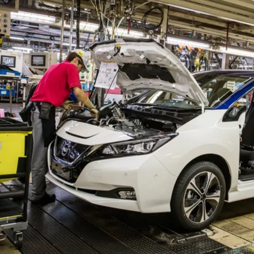 Worker doing work on a nissan leaf engine