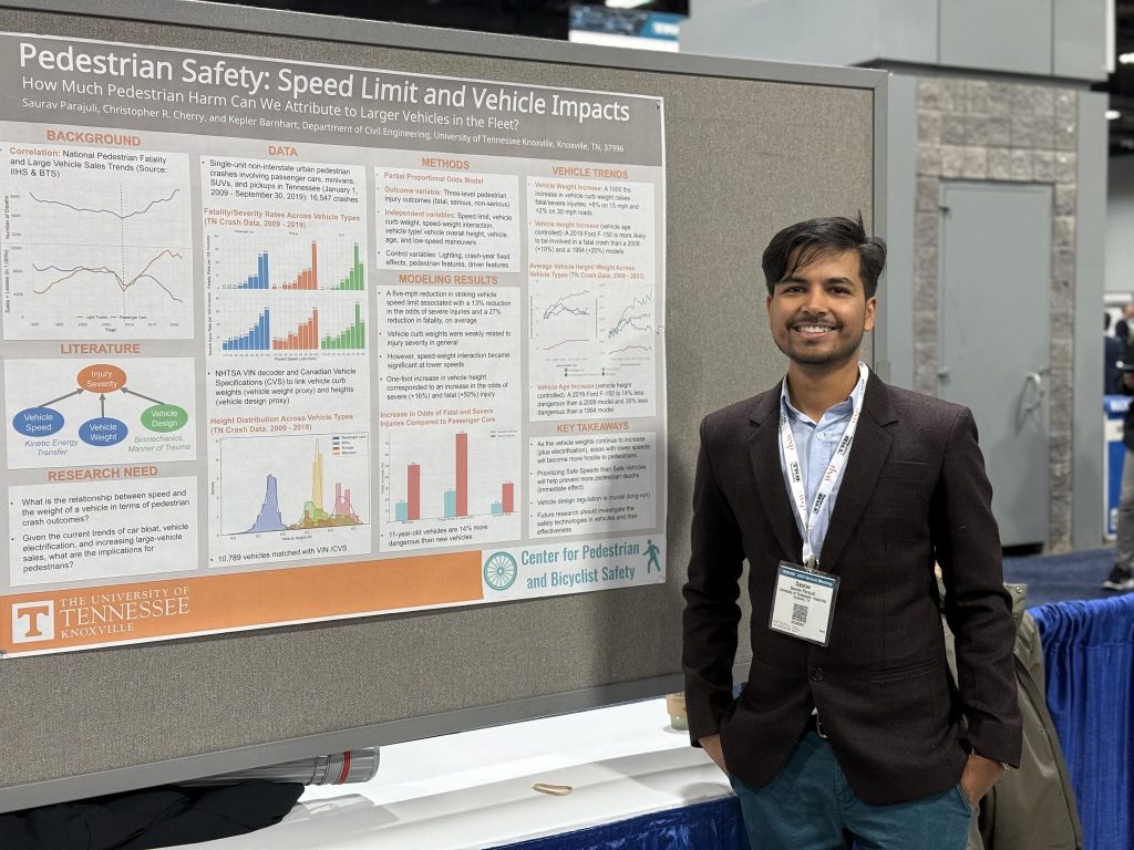 a student researcher posing in front of his research project poster at the 2025 TRB conference