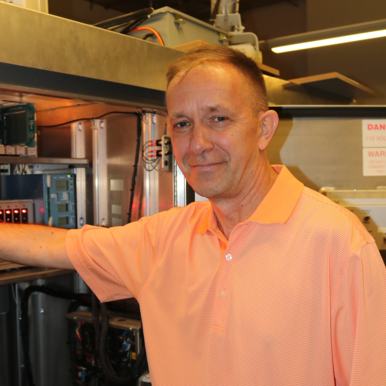 Dr. Kohls in front of a traffic signal control computer