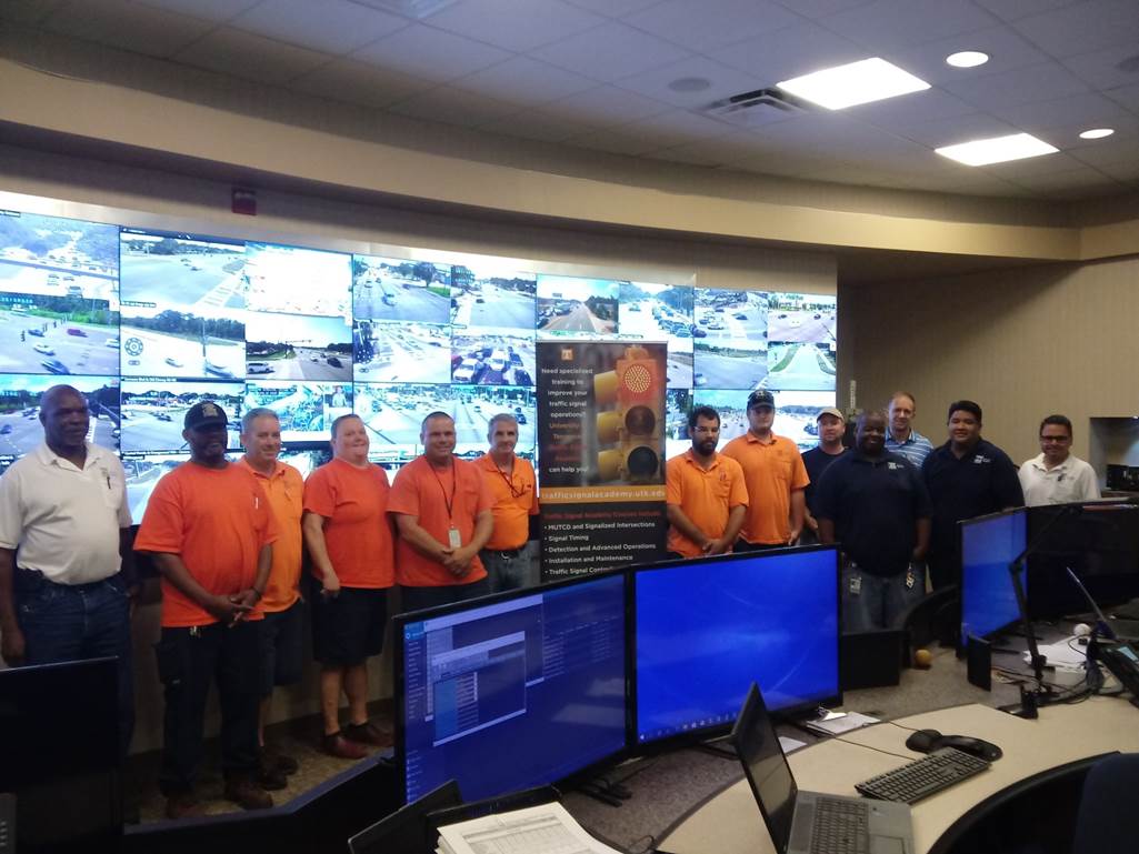 TSA students pose in fornt of TDOTs live road view screens