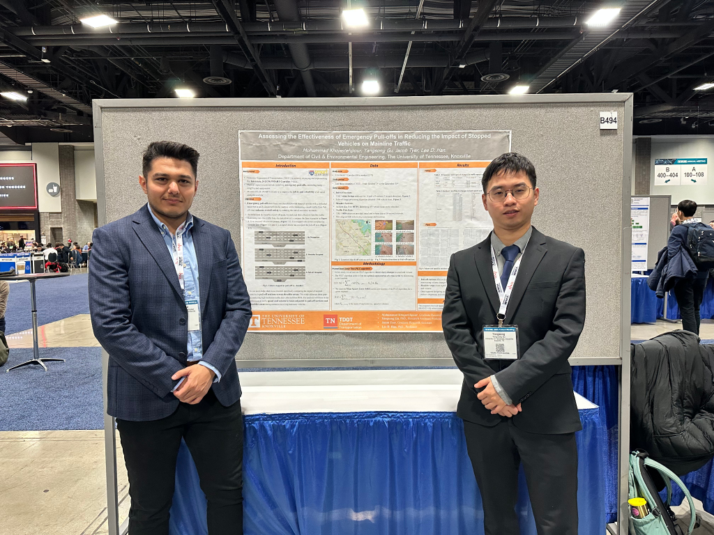 two student researchers posing in front of their research project poster at the 2025 TRB conference